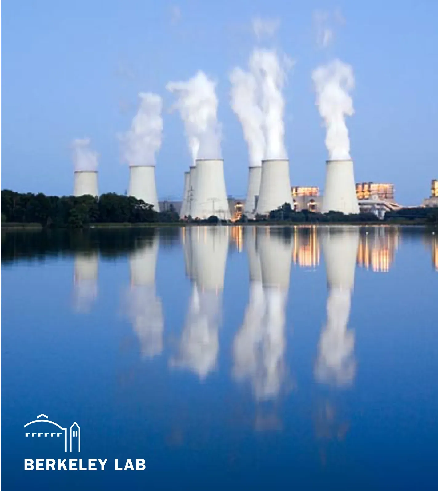 Industrial cooling towers reflected in water